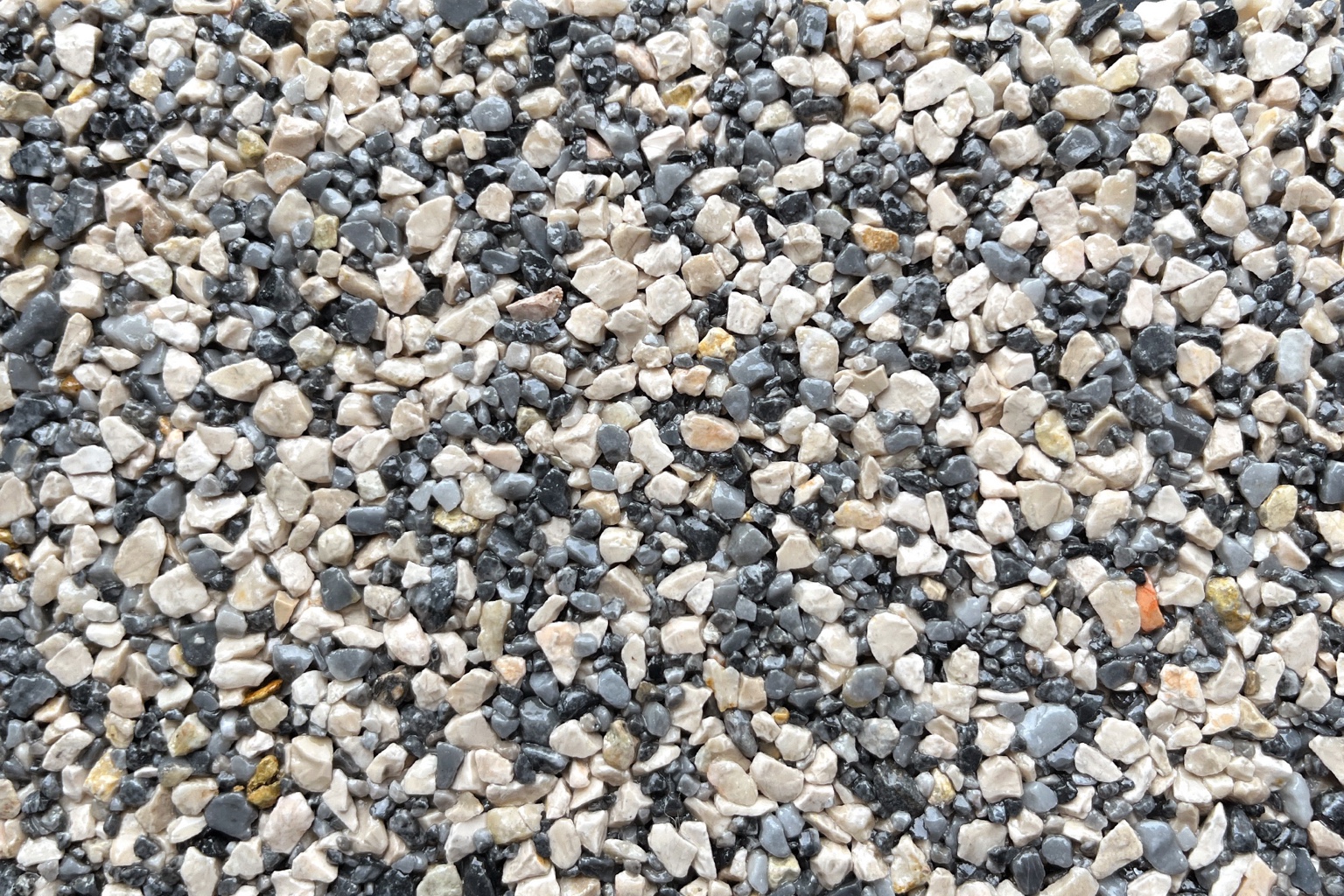 Close-up of natural aggregate in cream, gray and charcoal tones